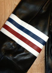 Close-up of red, white and blue stripe armband on right bicep.