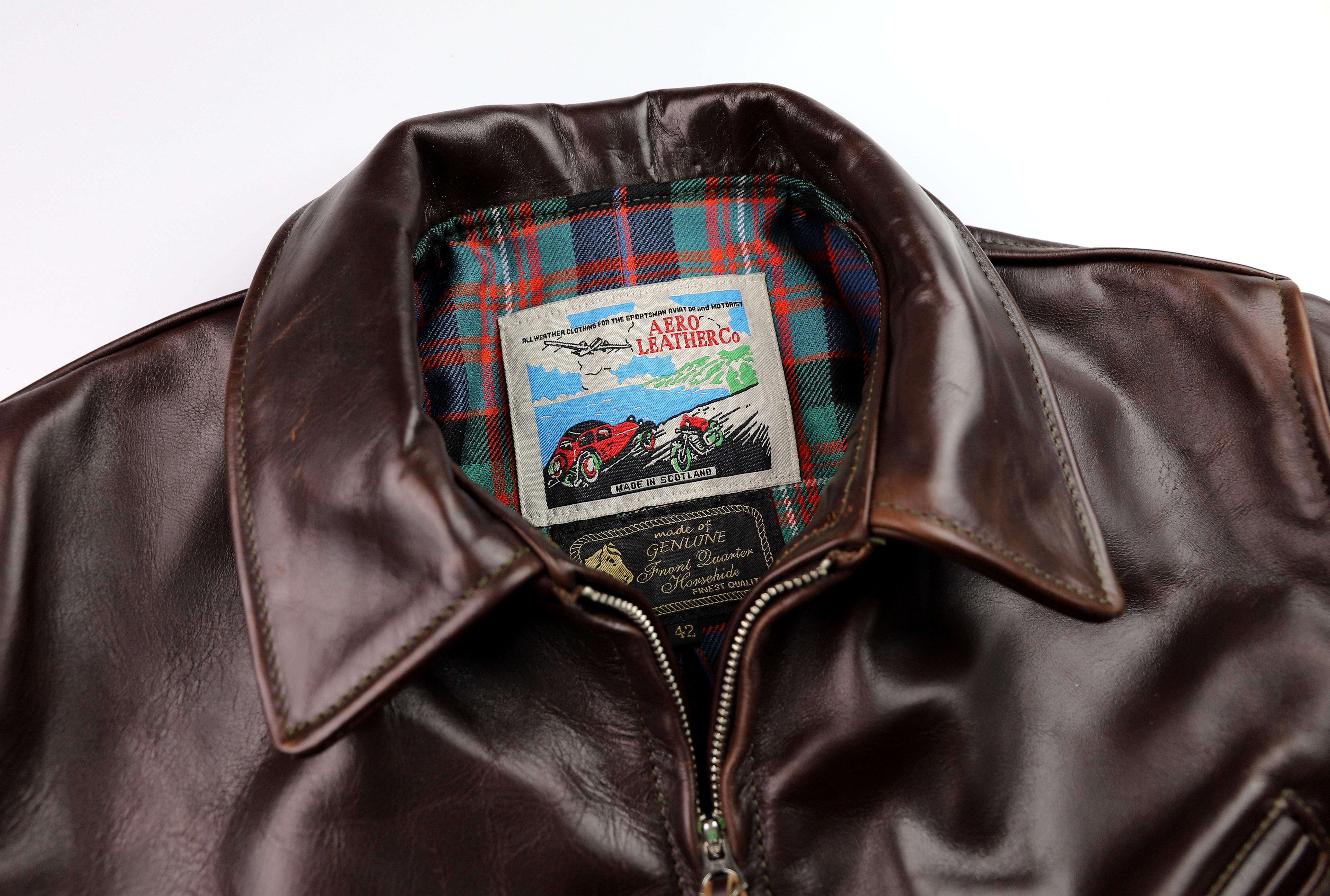 Close-up of Aero tag and brown leather shirt collar.