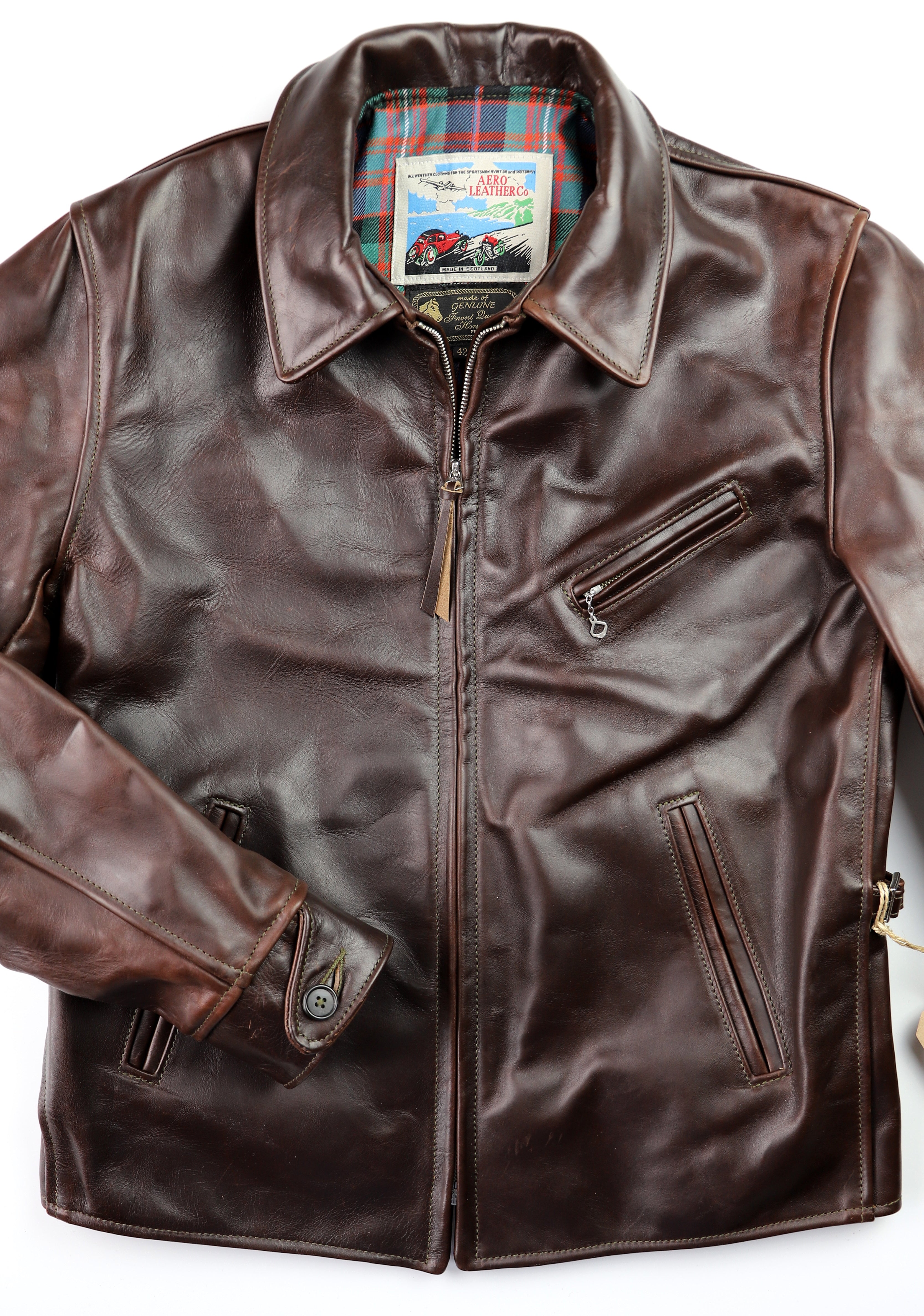 Brown leather jacket with straight front zipper, shirt collar and button sleeves.