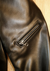 Close-up of angled bicep pocket on left side with nickel ring pull.