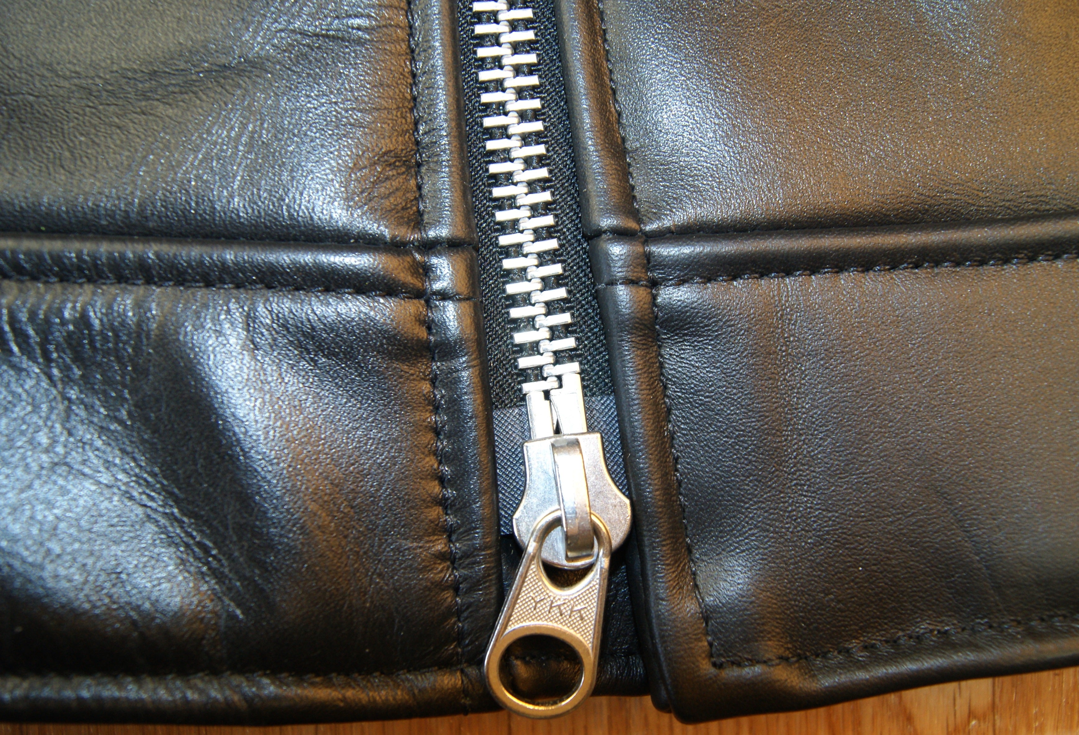 Close-up of bottom zipper on double-ended front zipper.