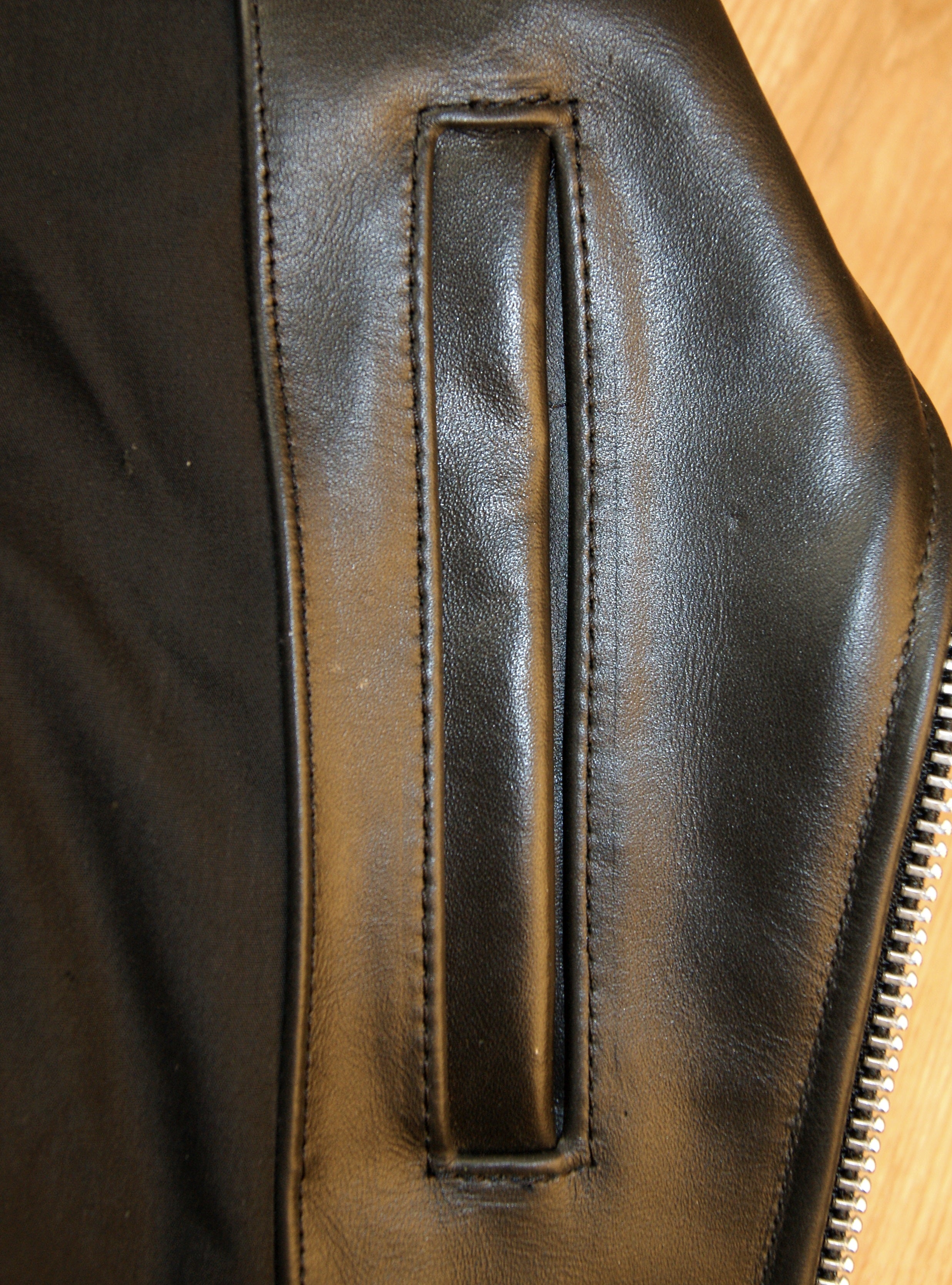 Close-up of left side interior pocket.  Opens vertically with no closure.