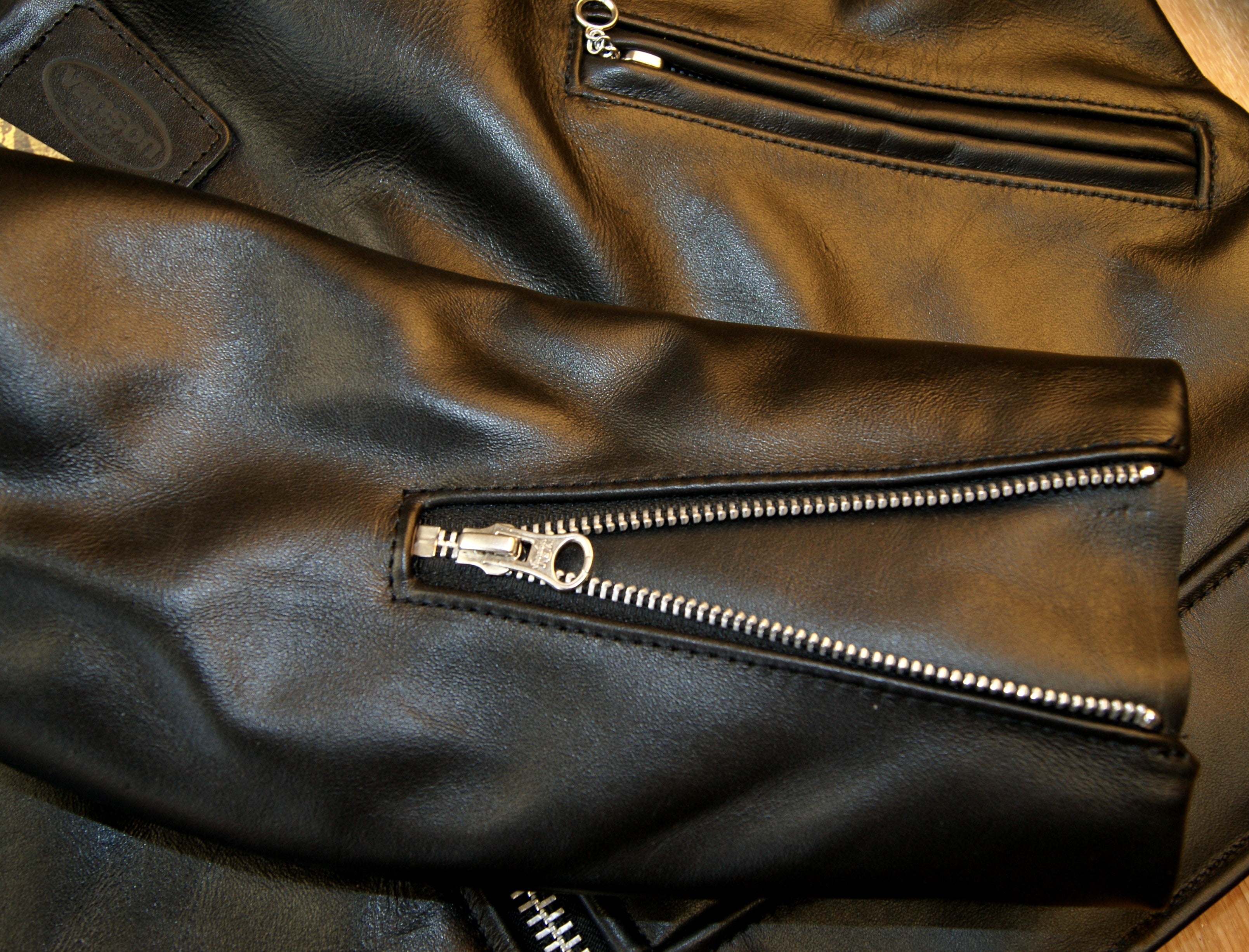 Close-up of zippered sleeves, open to show leather gusset.
